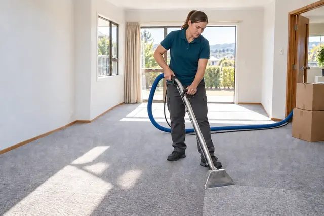 Cleaning carpet in an empty room before moving out